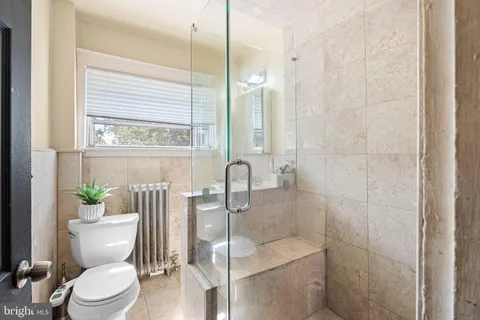 a bathroom with a toilet a sink and tub