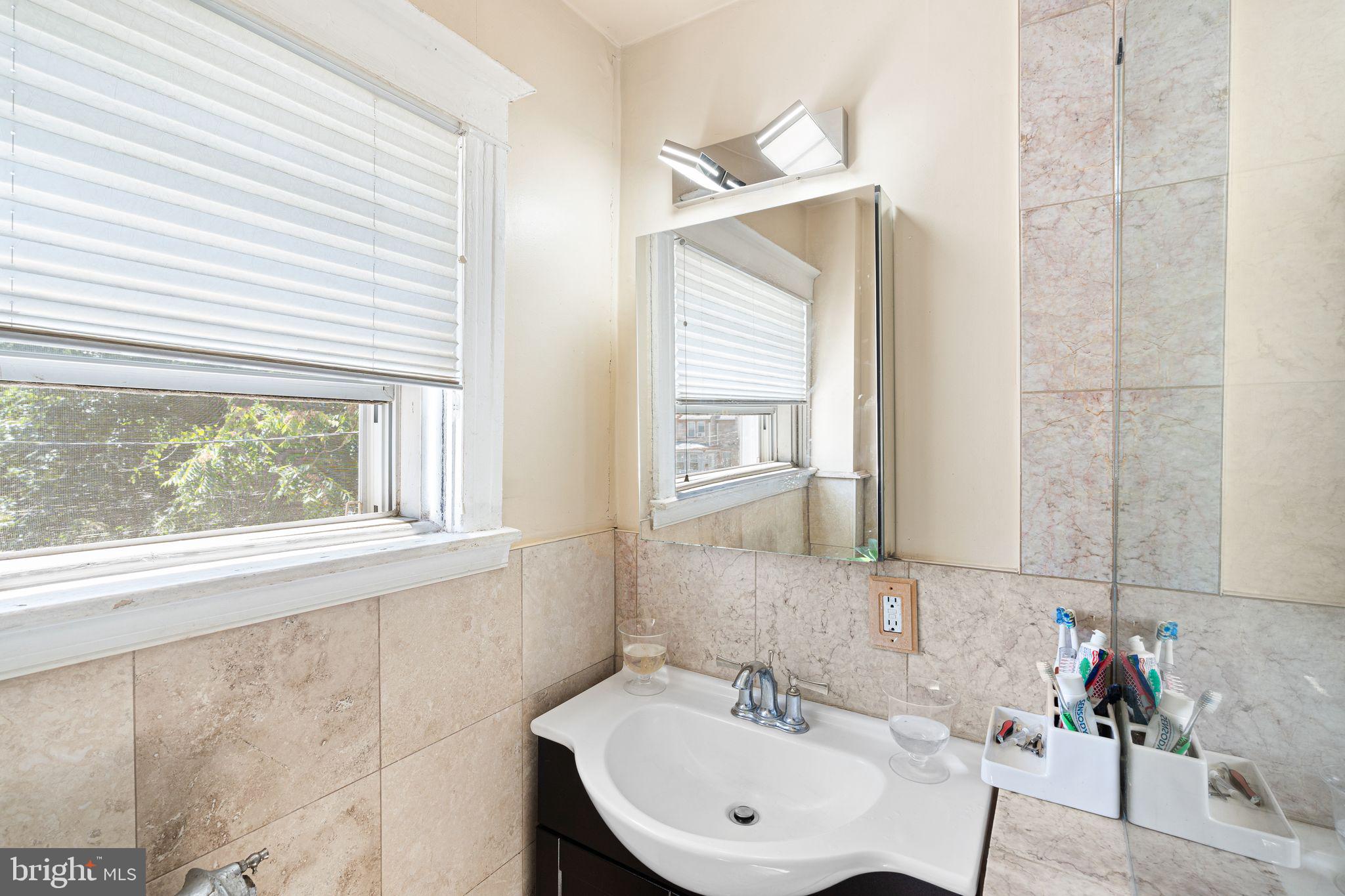 144 Fairview Avenue Lansdowne, PA 19050 - Photo 19 of 39 a bathroom with a sink and a mirror