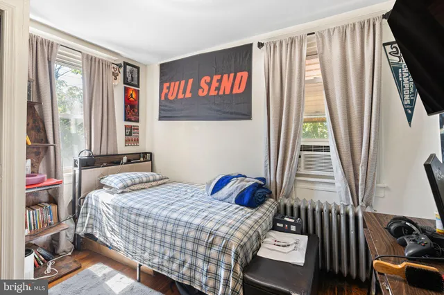 a bedroom with a bed and a window