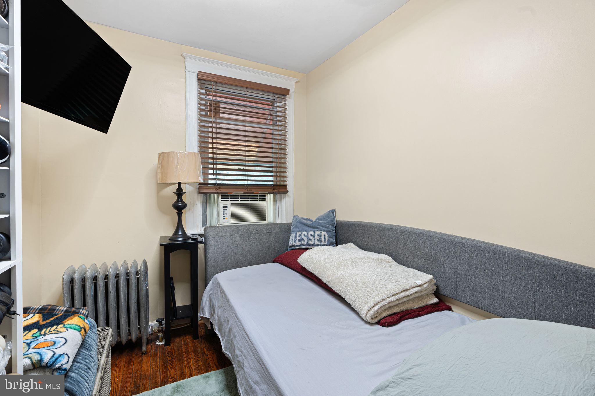 144 Fairview Avenue Lansdowne, PA 19050 - Photo 22 of 39 a bedroom with a bed a flat screen tv and a window