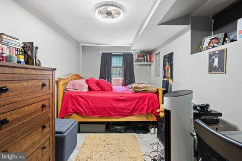 a bedroom with a bed and dresser