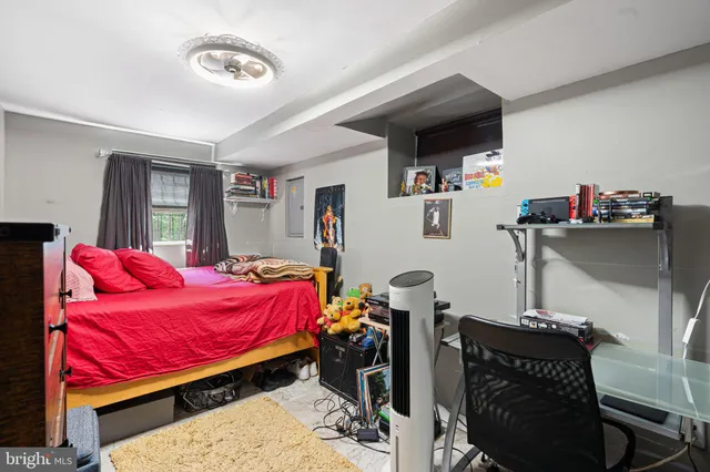 a bedroom with furniture and a flat screen tv