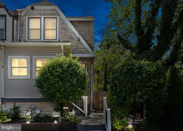 a front view of a house with plants