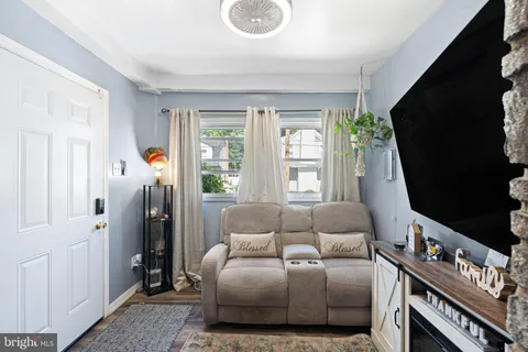 a bedroom with furniture and a flat screen tv
