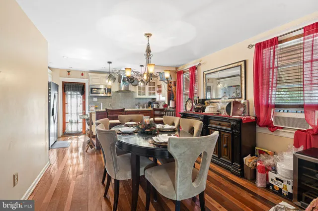 a view of a dining room with furniture and chandelier