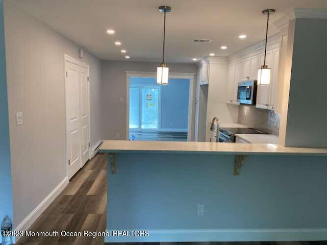 48 East Piazza Tasso Freehold, NJ 07728 - Photo 19 of 21 a kitchen with a refrigerator and a sink