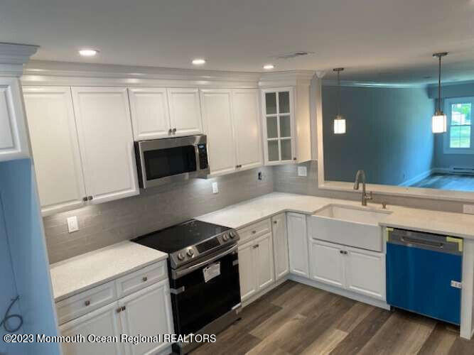 48 East Piazza Tasso Freehold, NJ 07728 - Photo 20 of 21 a kitchen with a sink appliances and cabinets