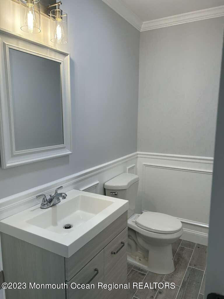 48 East Piazza Tasso Freehold, NJ 07728 - Photo 6 of 21 a white toilet sitting next to a bathroom sink