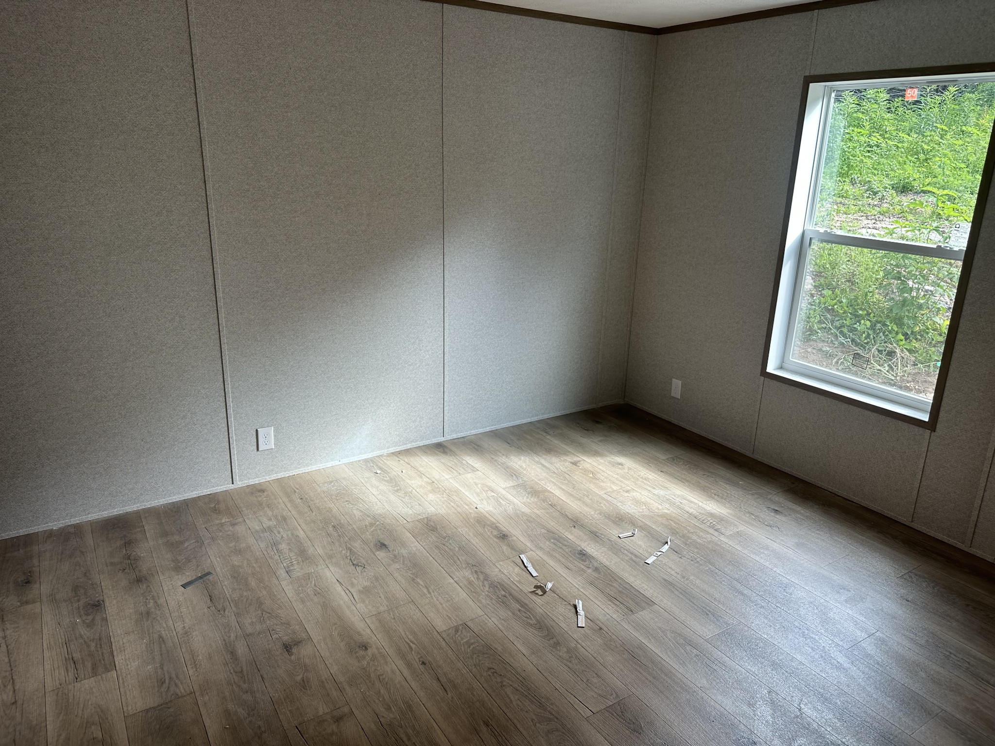 406 Shiloh Church Road Woodbury, TN 37190 - Photo 9 of 18 an empty room with wooden floor and windows