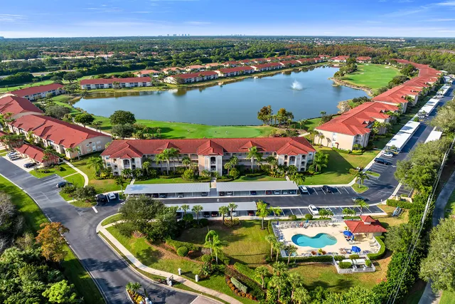 an aerial view of a house with a lake house swimming pool and outdoor seating