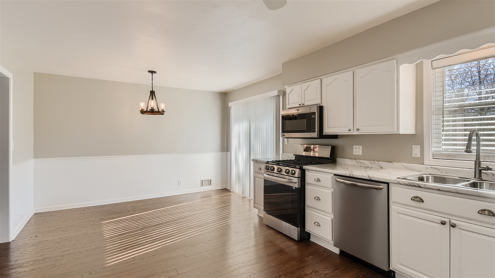 2438 Erskine Road Joliet, IL 60433 - Photo 11 of 42 a kitchen with granite countertop white cabinets and stainless steel appliances