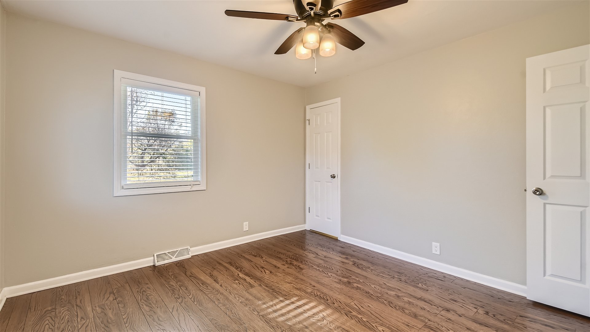 2438 Erskine Road Joliet, IL 60433 - Photo 12 of 42 a view of an empty room with wooden floor and a window