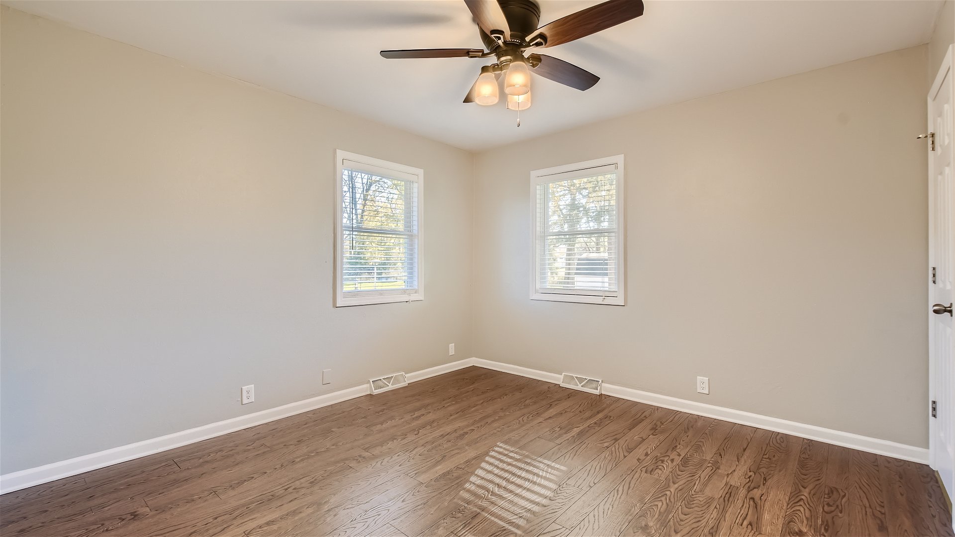 2438 Erskine Road Joliet, IL 60433 - Photo 14 of 42 a view of an empty room with wooden floor and a window