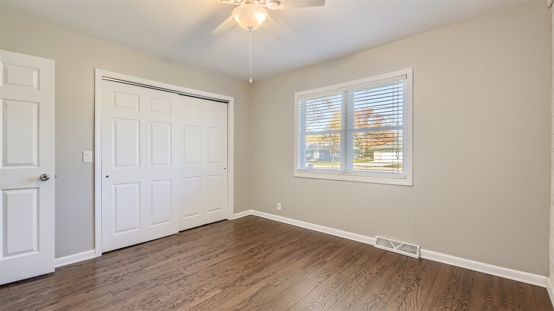 2438 Erskine Road Joliet, IL 60433 - Photo 17 of 42 a view of an empty room with wooden floor and a window