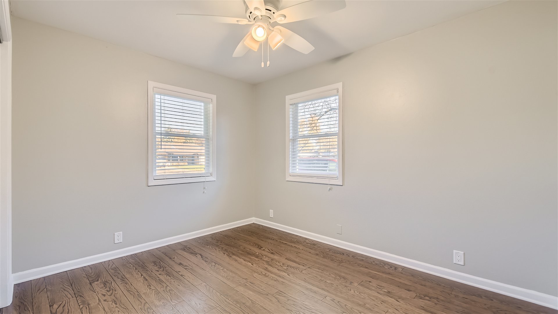 2438 Erskine Road Joliet, IL 60433 - Photo 19 of 42 an empty room with wooden floor windows and fan