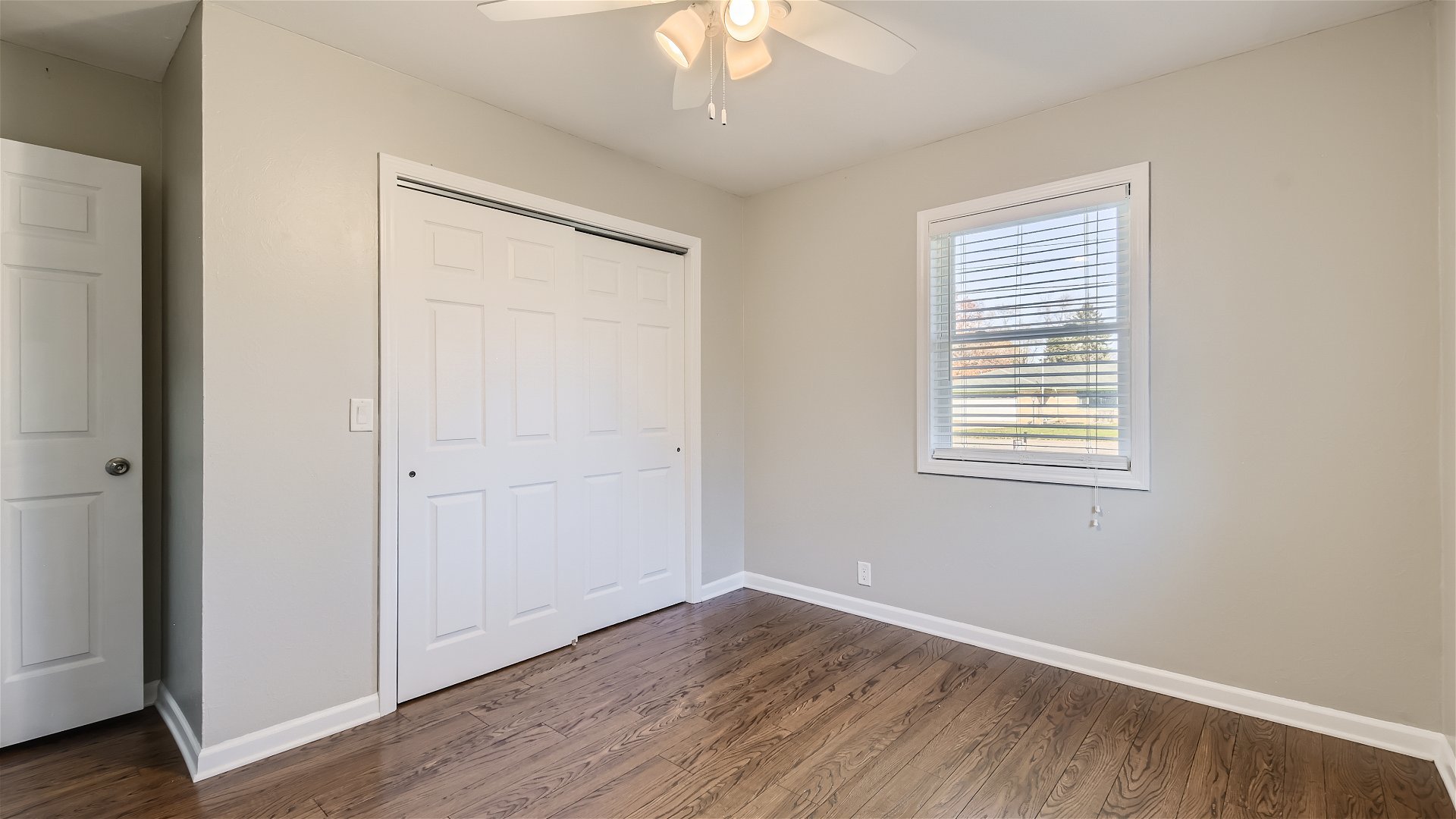 2438 Erskine Road Joliet, IL 60433 - Photo 20 of 42 a view of an empty room with wooden floor and a window