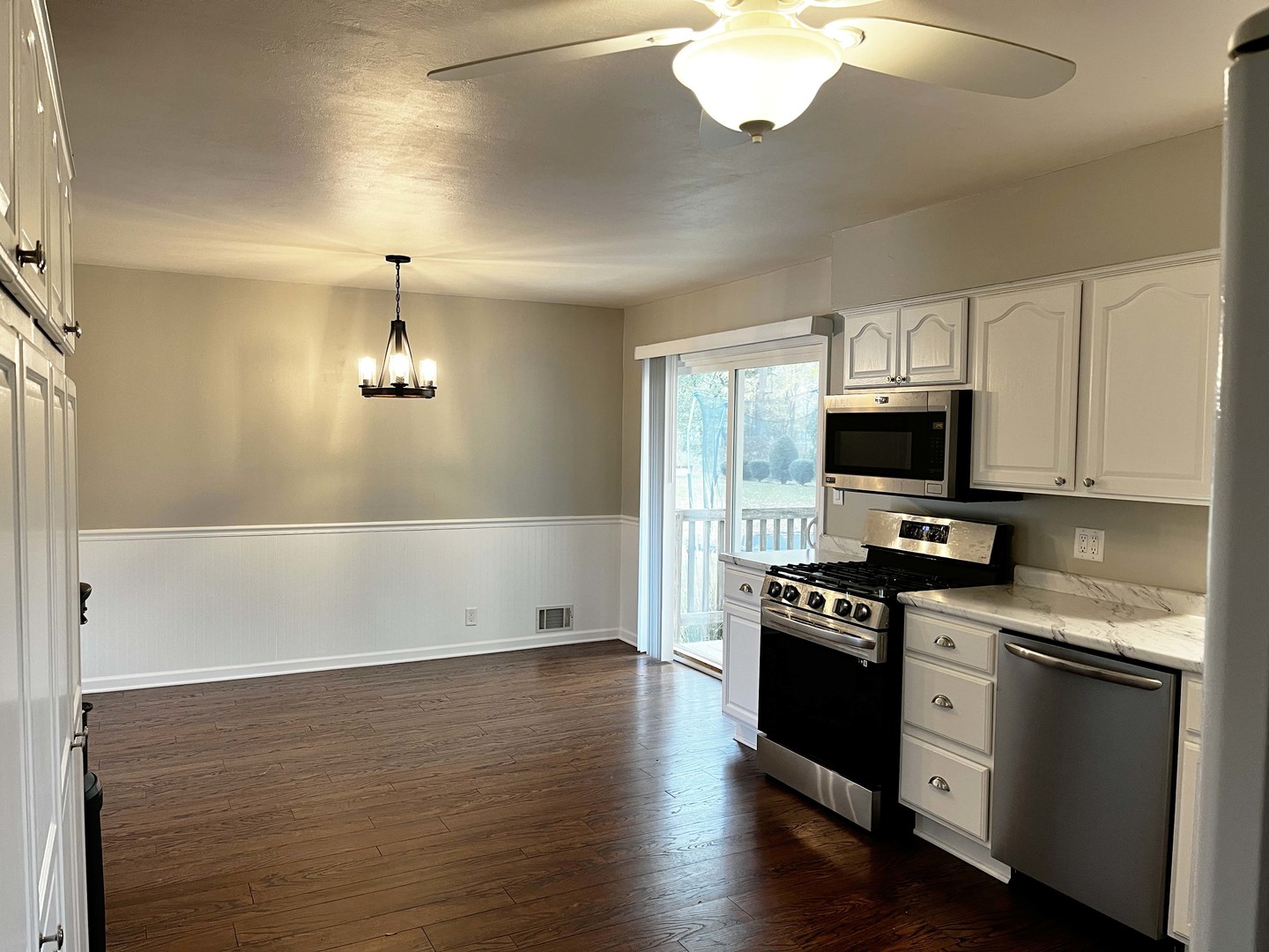 2438 Erskine Road Joliet, IL 60433 - Photo 24 of 42 a kitchen with stainless steel appliances a stove cabinets and wooden floor