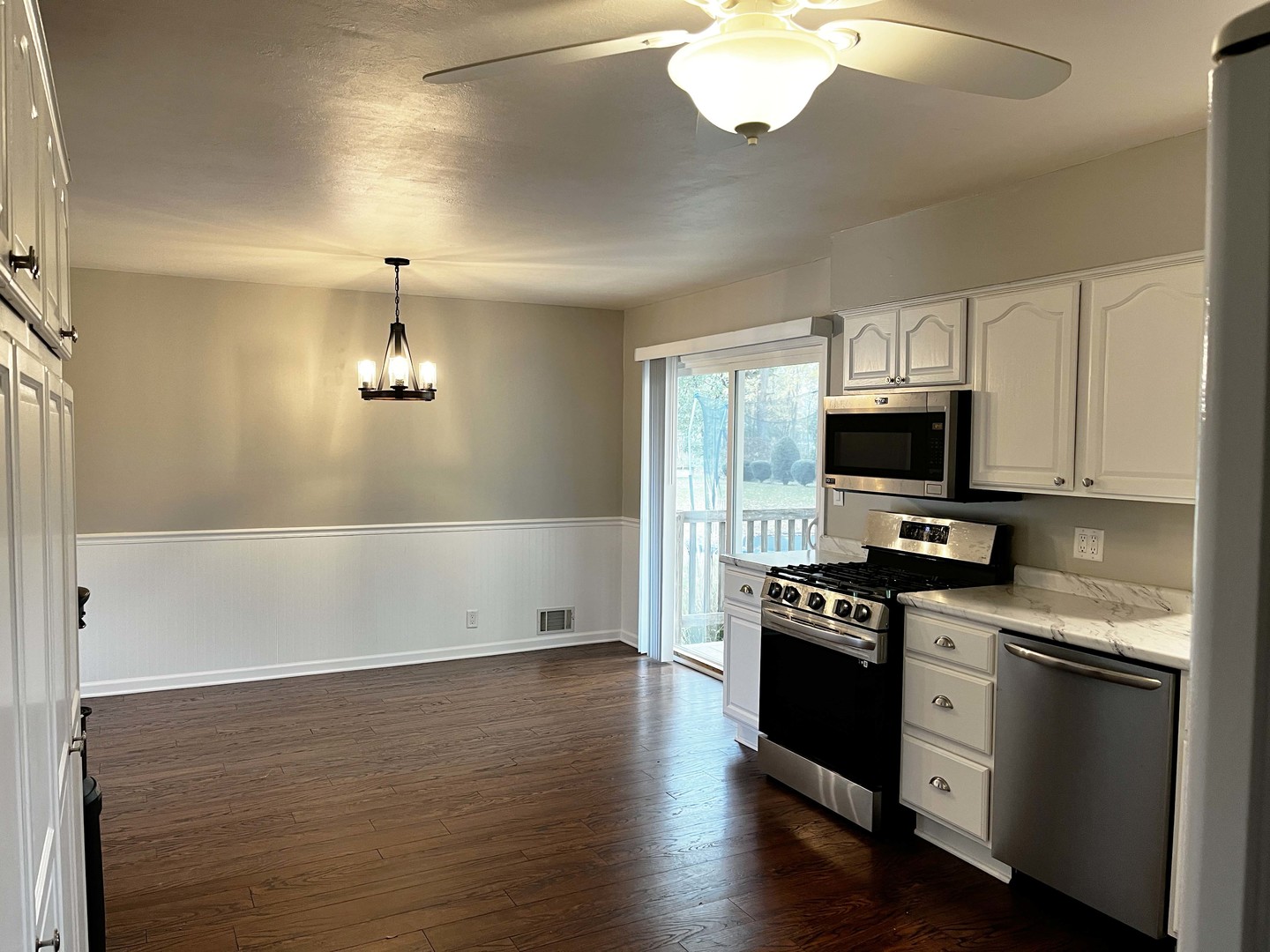 2438 Erskine Road Joliet, IL 60433 - Photo 25 of 42 a kitchen with stainless steel appliances a stove cabinets and wooden floor
