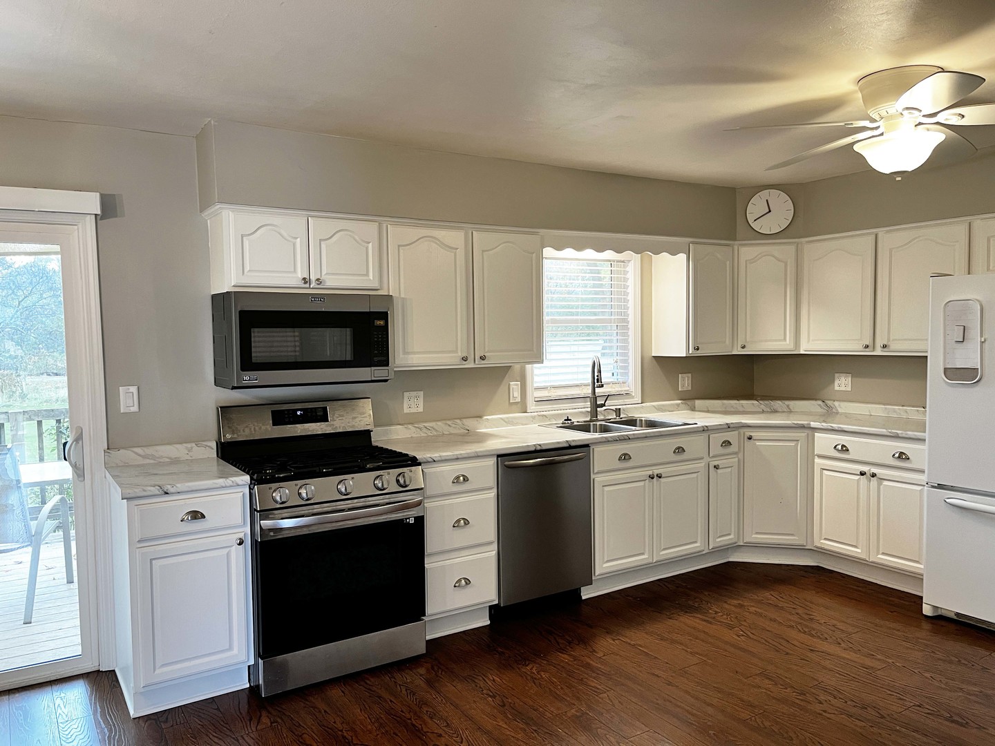 2438 Erskine Road Joliet, IL 60433 - Photo 26 of 42 a kitchen with granite countertop a sink cabinets and stainless steel appliances