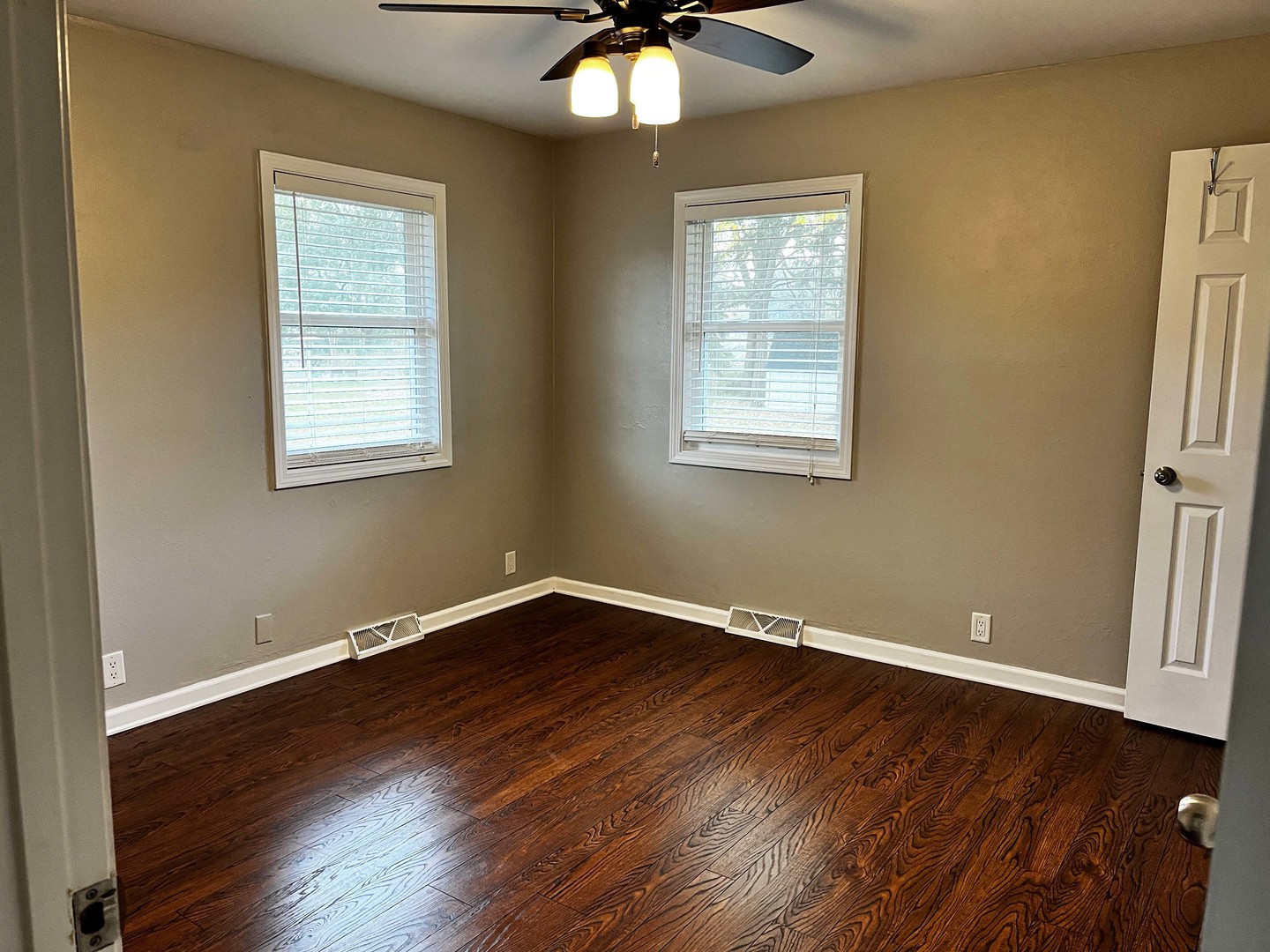 2438 Erskine Road Joliet, IL 60433 - Photo 31 of 42 a view of an empty room with wooden floor and a window