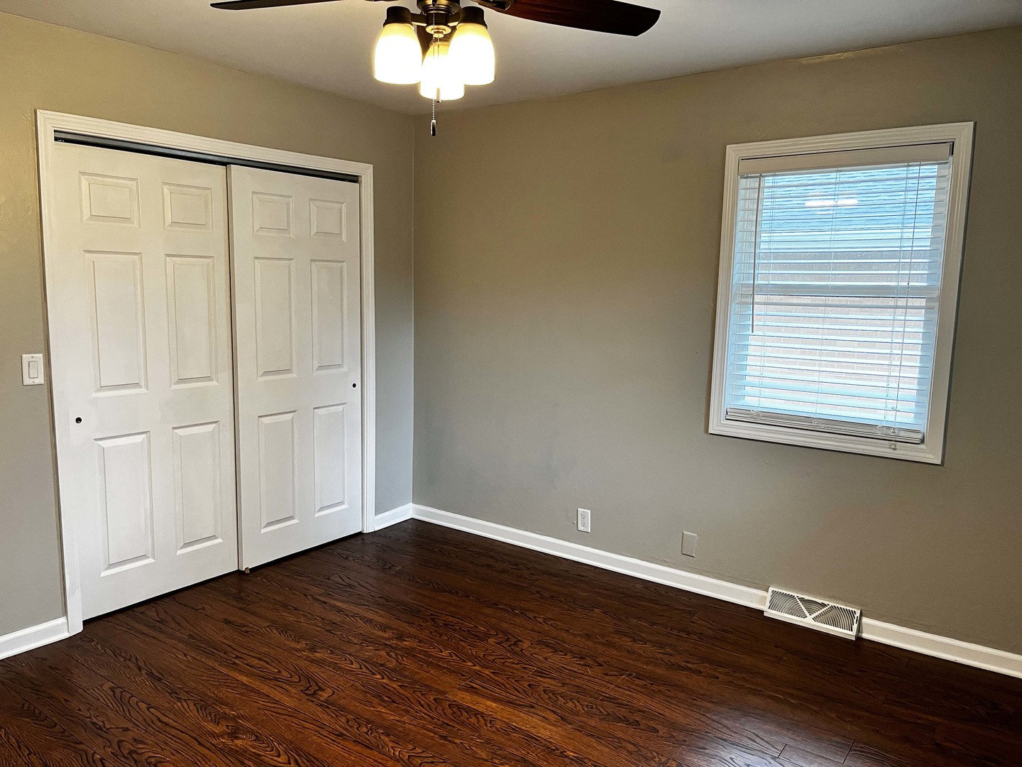 2438 Erskine Road Joliet, IL 60433 - Photo 32 of 42 a view of an empty room with wooden floor and a window