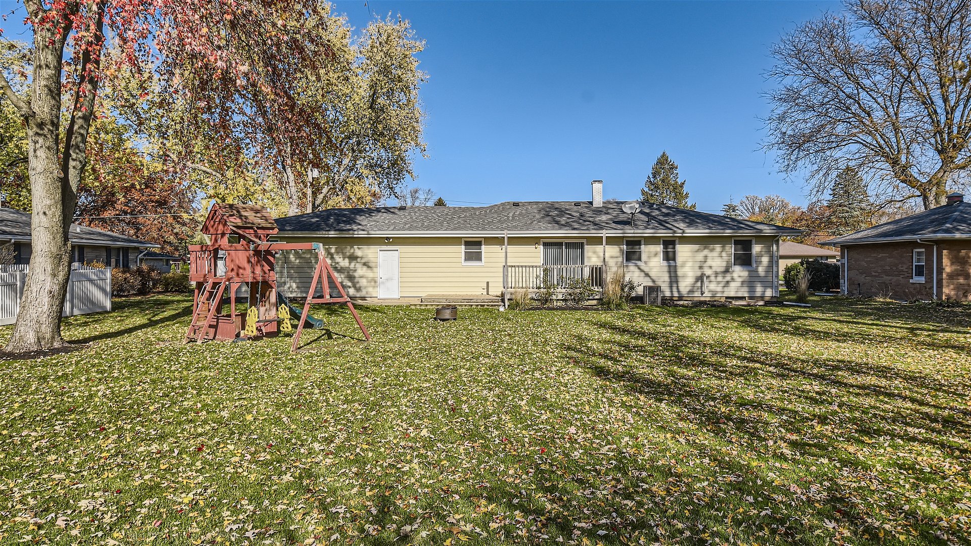 2438 Erskine Road Joliet, IL 60433 - Photo 40 of 42 a white house that has a tree in front of it