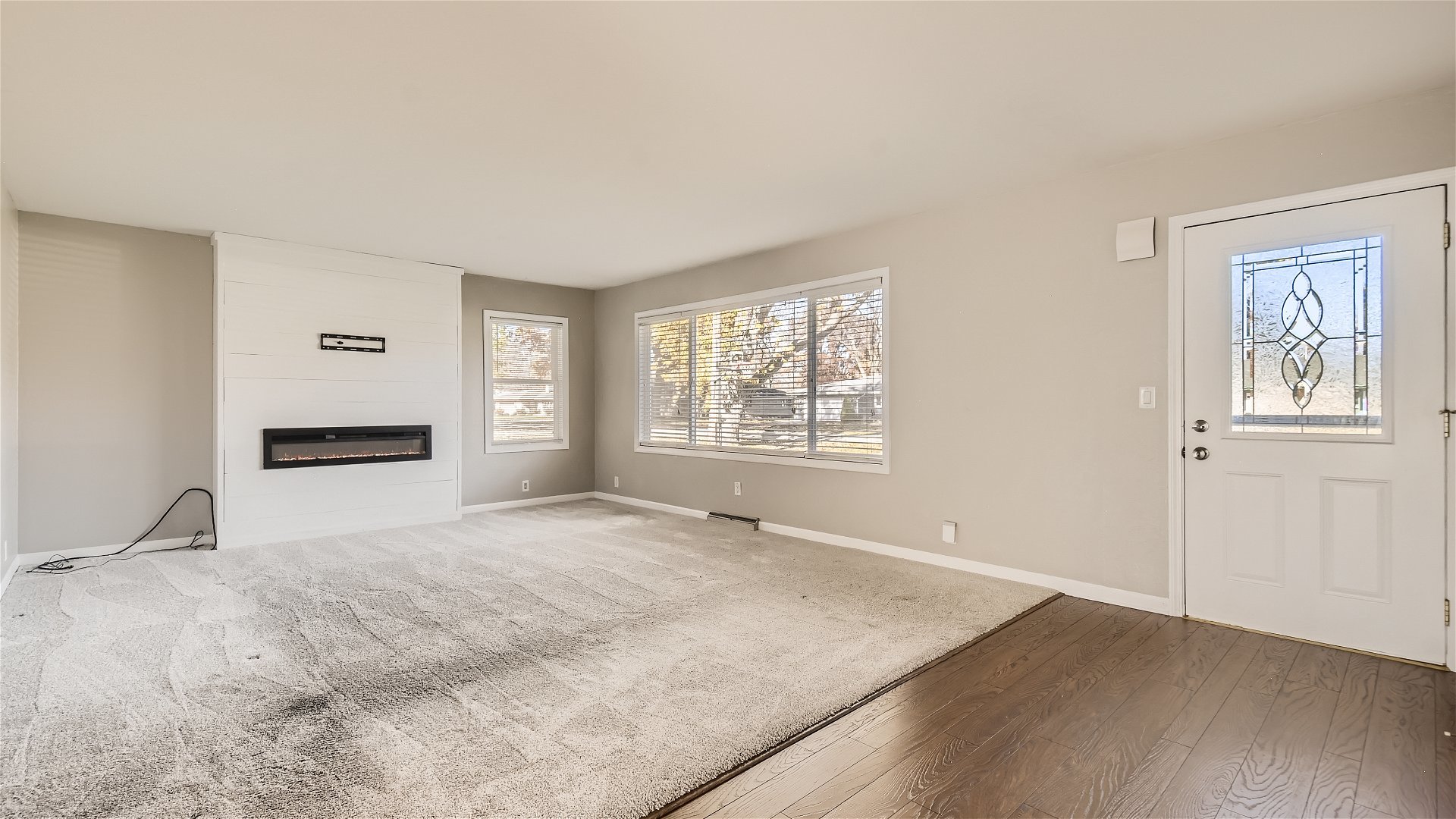 2438 Erskine Road Joliet, IL 60433 - Photo 6 of 42 a view of an empty room with a window and a kitchen
