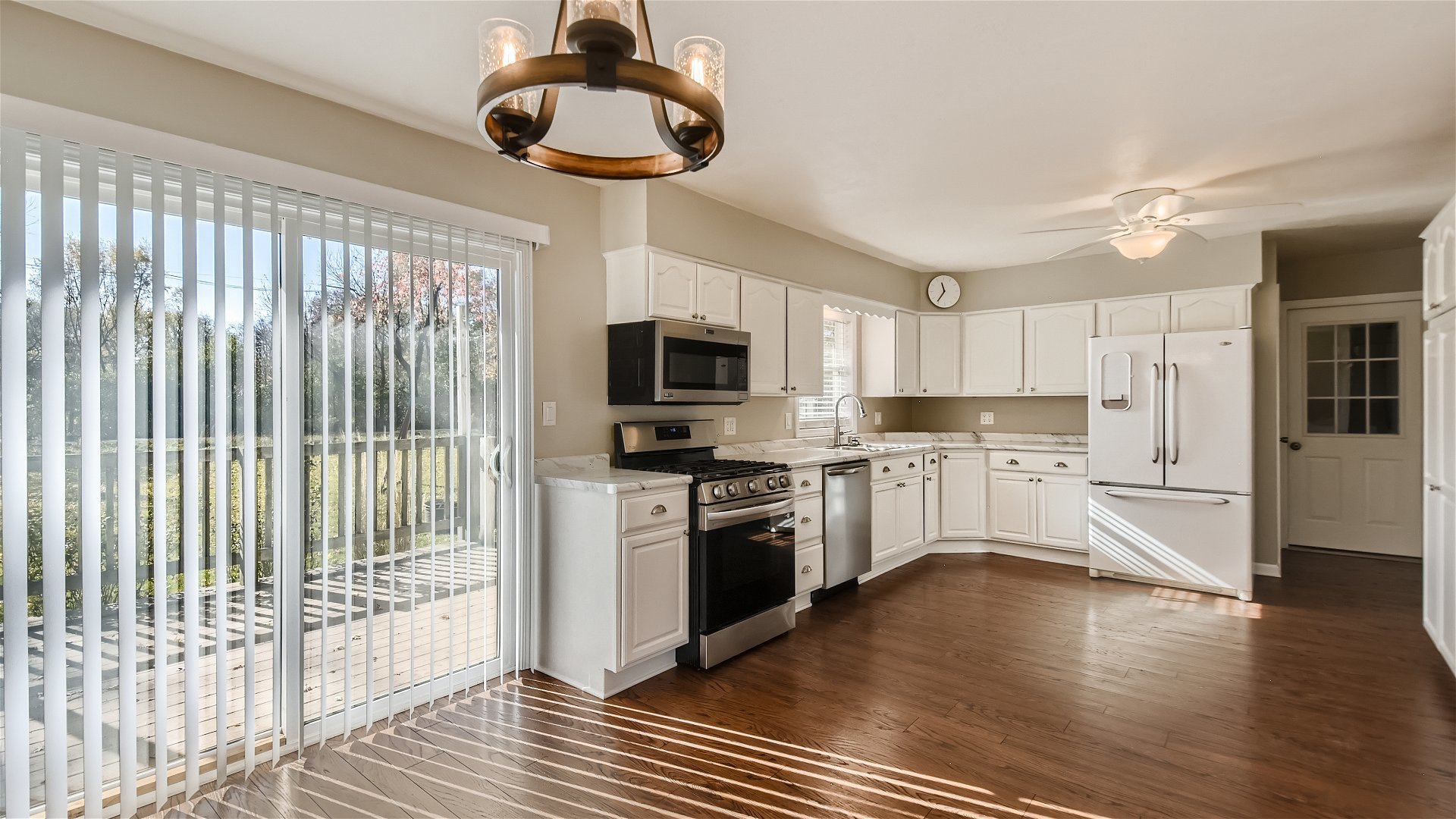 2438 Erskine Road Joliet, IL 60433 - Photo 8 of 42 a kitchen with stainless steel appliances granite countertop a stove top oven a refrigerator a sink and dishwasher with wooden floor