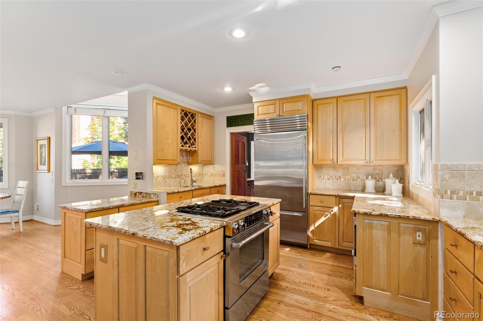 2435 South Fillmore Street Denver, CO 80210 - Photo 12 of 32 a kitchen that has a sink and a stove in it