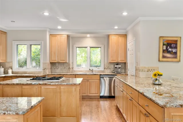 a kitchen with granite countertop a sink and a stove top oven