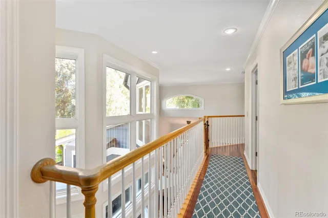 a view of staircase with furniture and a window