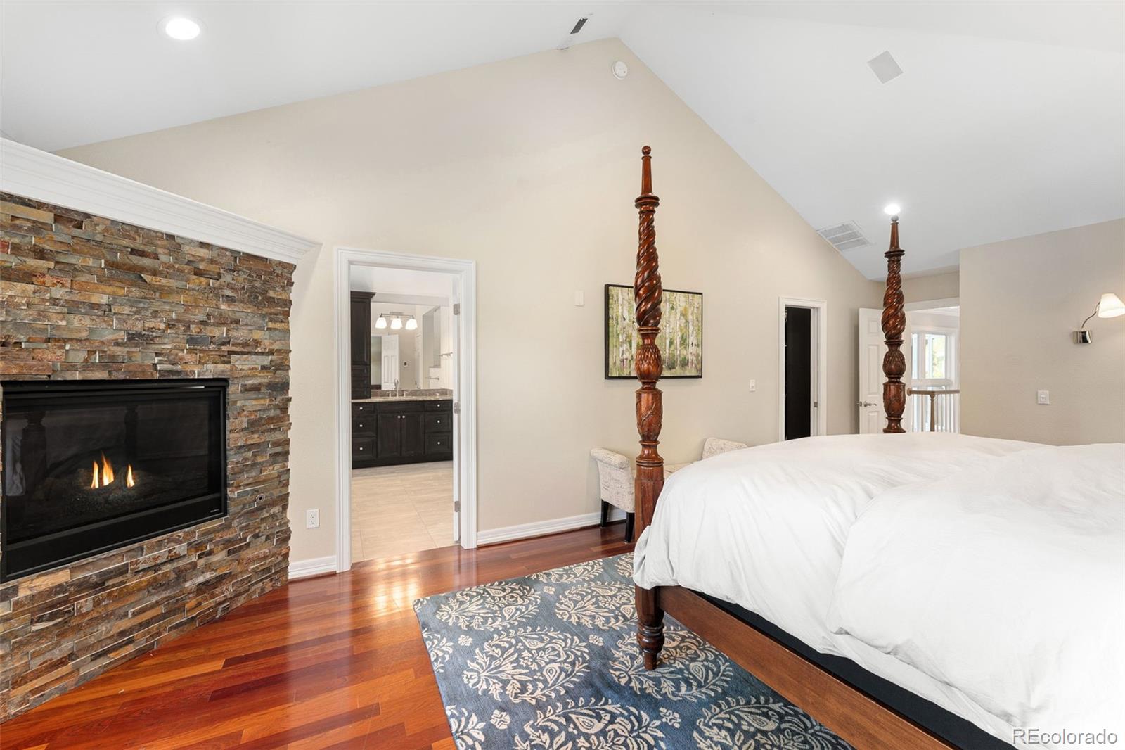 2435 South Fillmore Street Denver, CO 80210 - Photo 20 of 32 a spacious bedroom with a bed and a fireplace