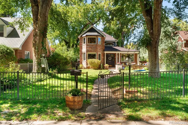 a front view of a house with a garden and plants