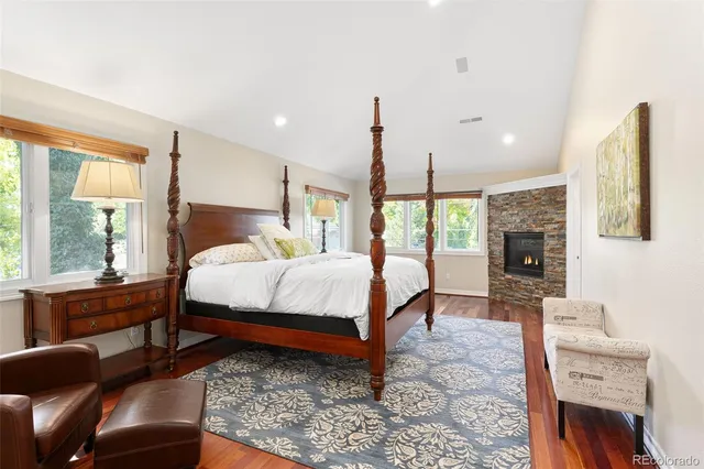 a bed room with a bed window and a chair