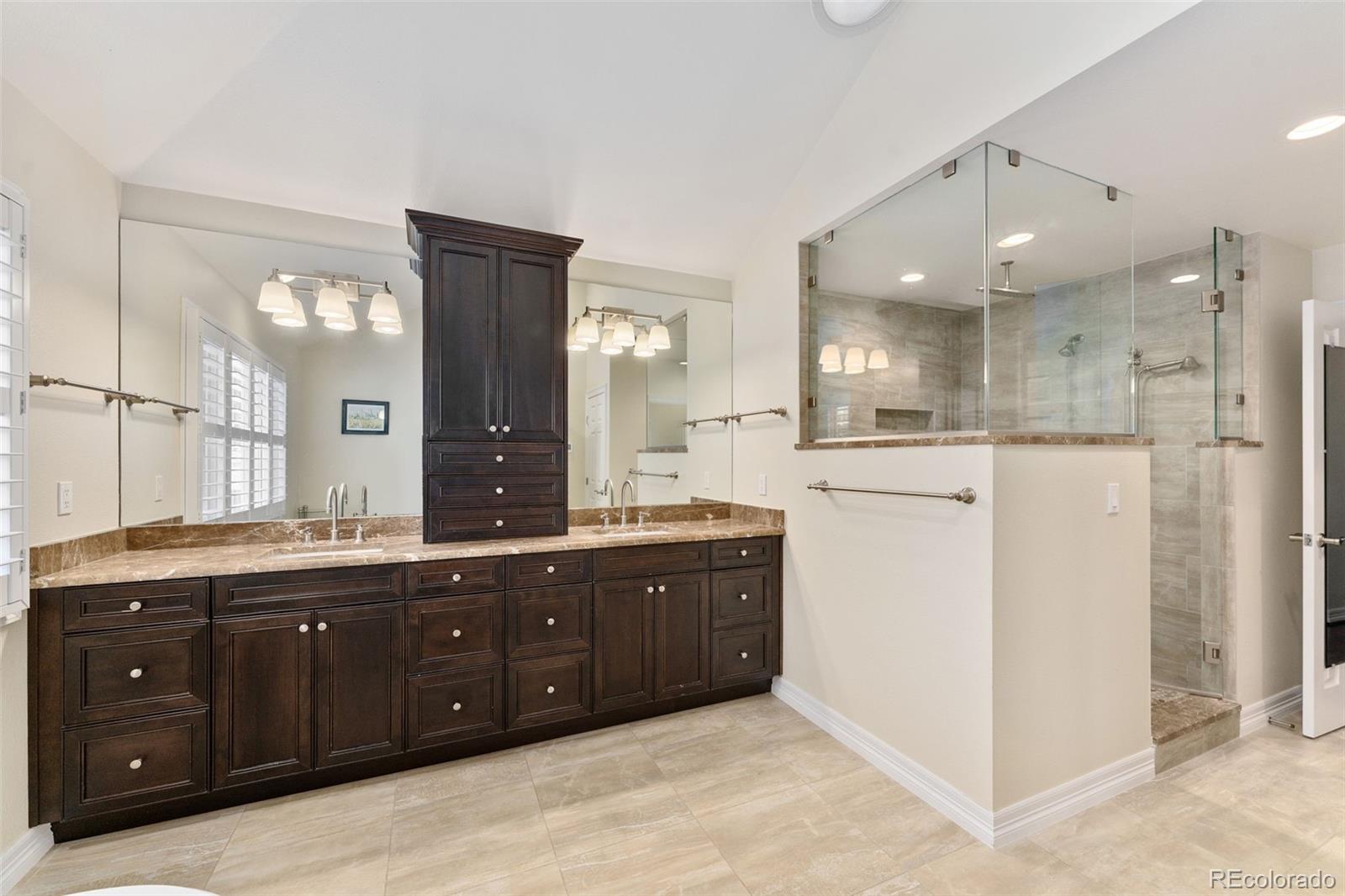 2435 South Fillmore Street Denver, CO 80210 - Photo 21 of 32 a spacious bathroom with a granite countertop sink mirror and shower