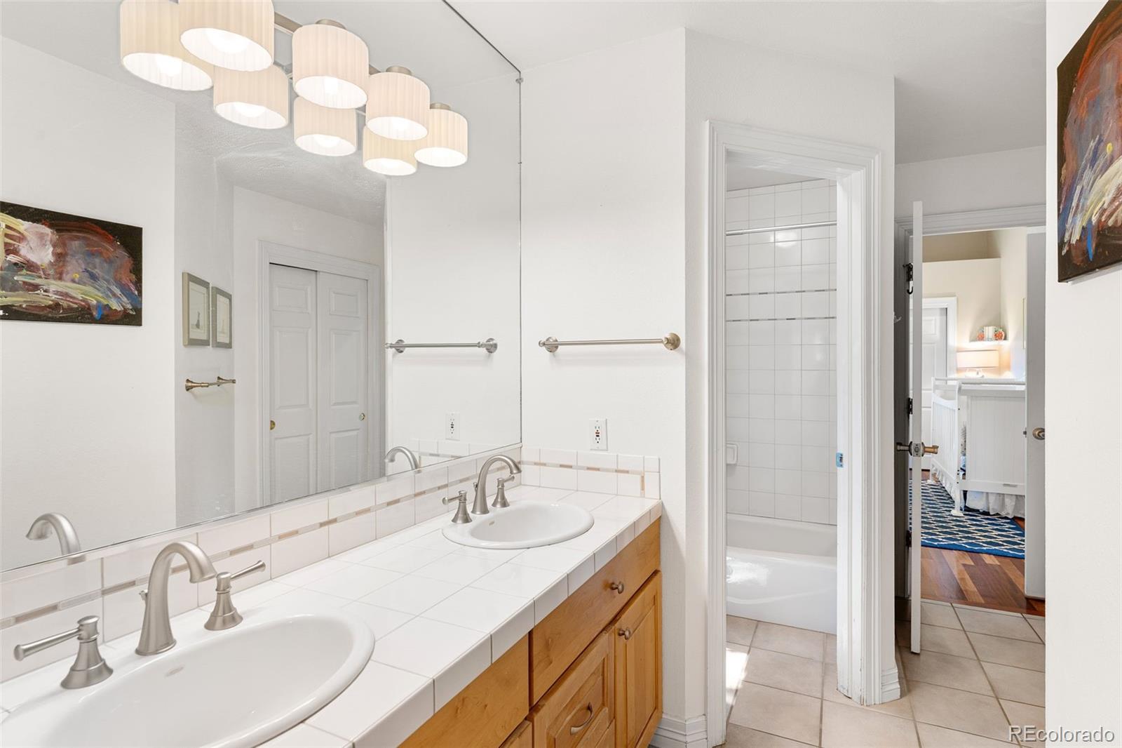 2435 South Fillmore Street Denver, CO 80210 - Photo 24 of 32 a bathroom with a sink and a mirror
