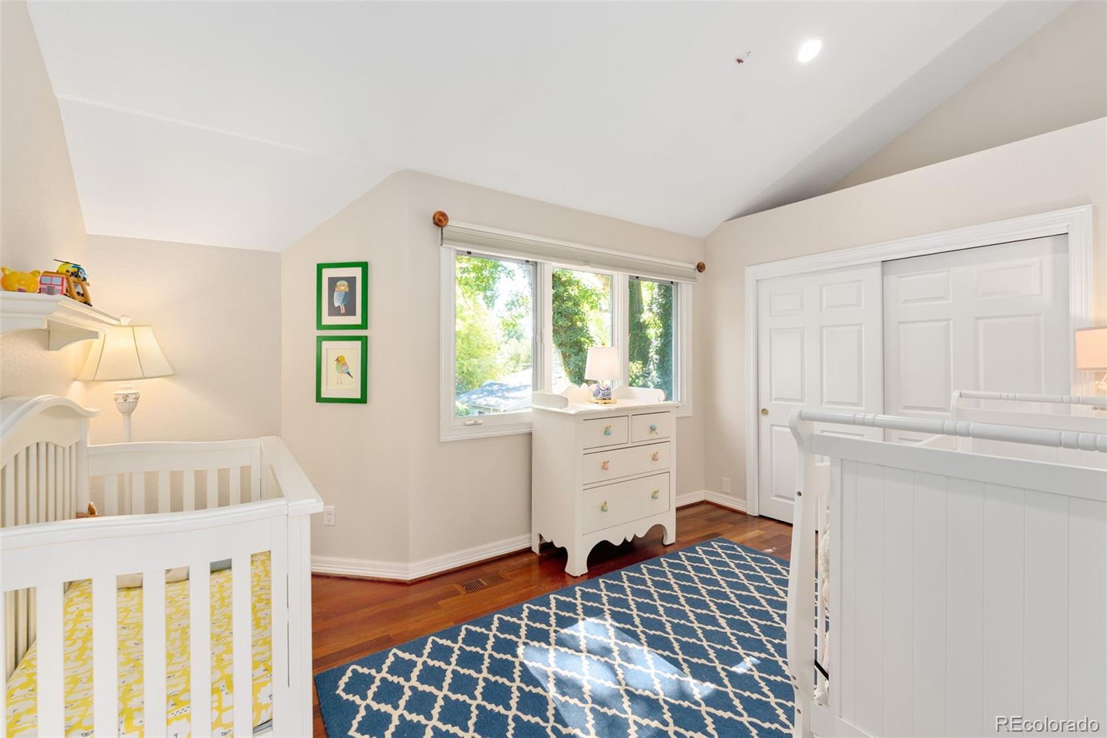2435 South Fillmore Street Denver, CO 80210 - Photo 25 of 32 a bedroom with a bed and a window