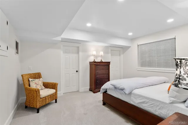 a spacious bedroom with a bed and a couch