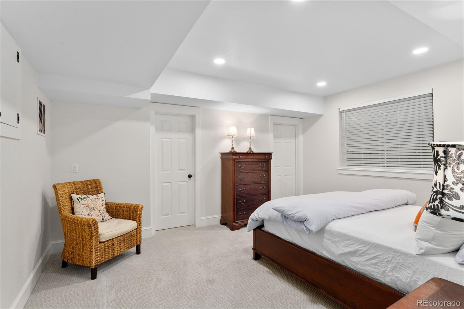 2435 South Fillmore Street Denver, CO 80210 - Photo 27 of 32 a spacious bedroom with a bed and a couch