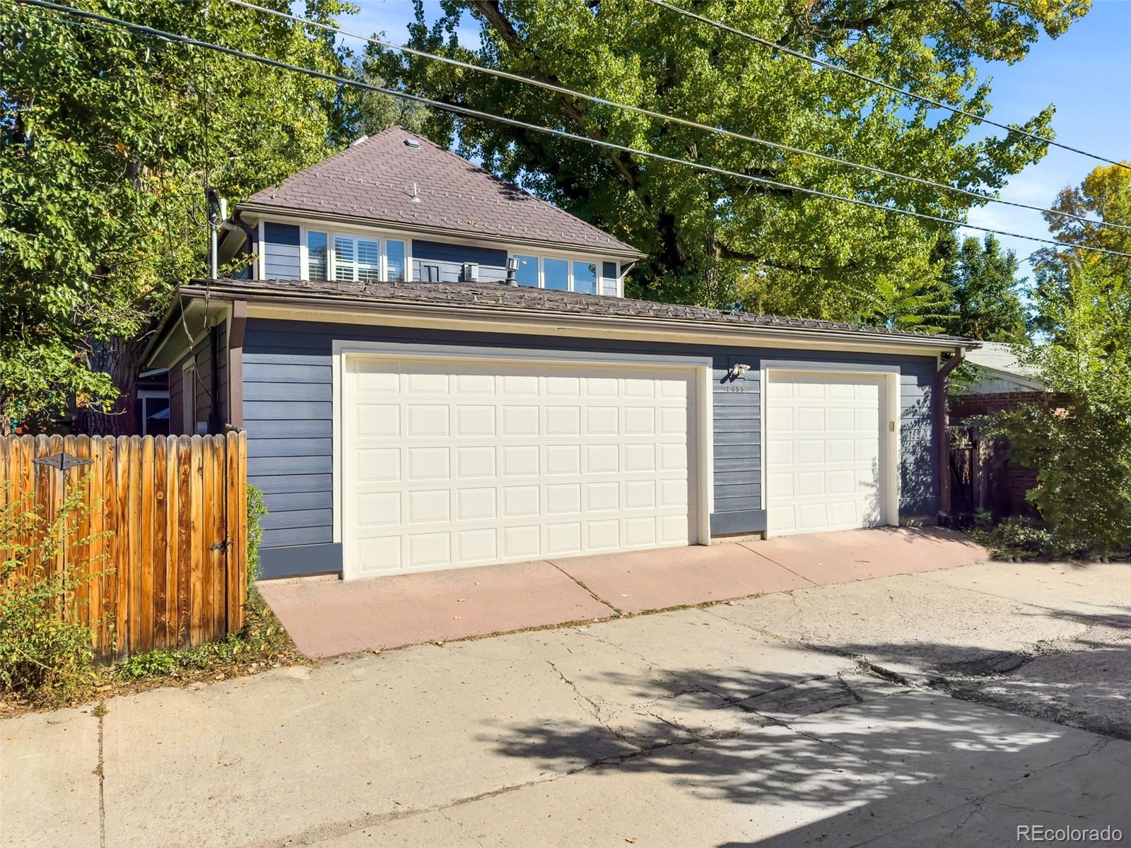 2435 South Fillmore Street Denver, CO 80210 - Photo 30 of 32 a front view of a house with a yard and garage