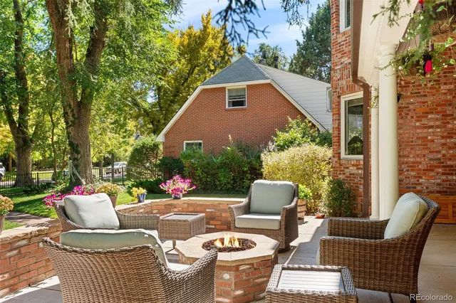 a view of a patio with couches table and chairs and potted plants