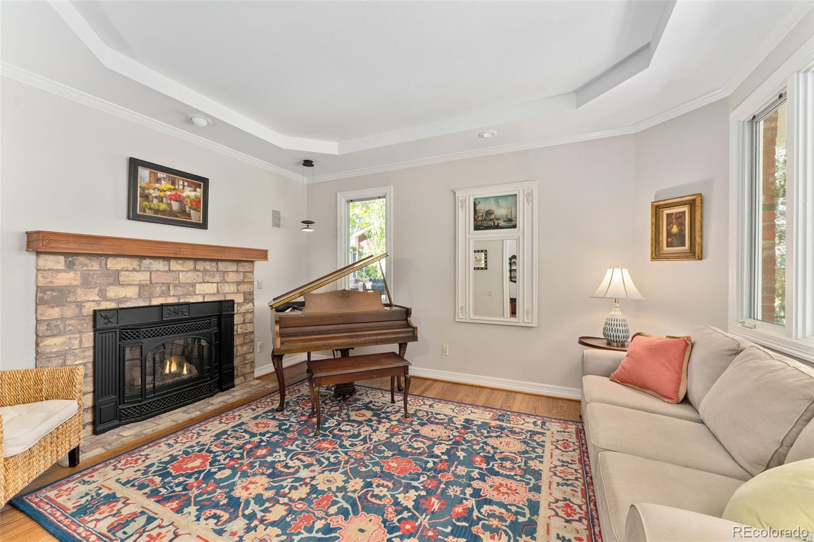 2435 South Fillmore Street Denver, CO 80210 - Photo 6 of 32 a living room with furniture a rug and a fireplace