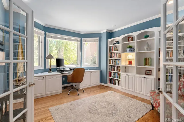 a view of a workspace with furniture and a window