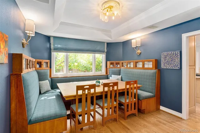 a dining room with furniture and a large window