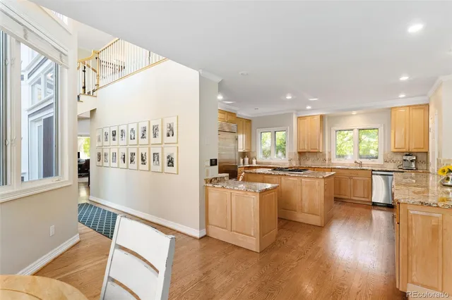 a kitchen with counter top space and wooden floor