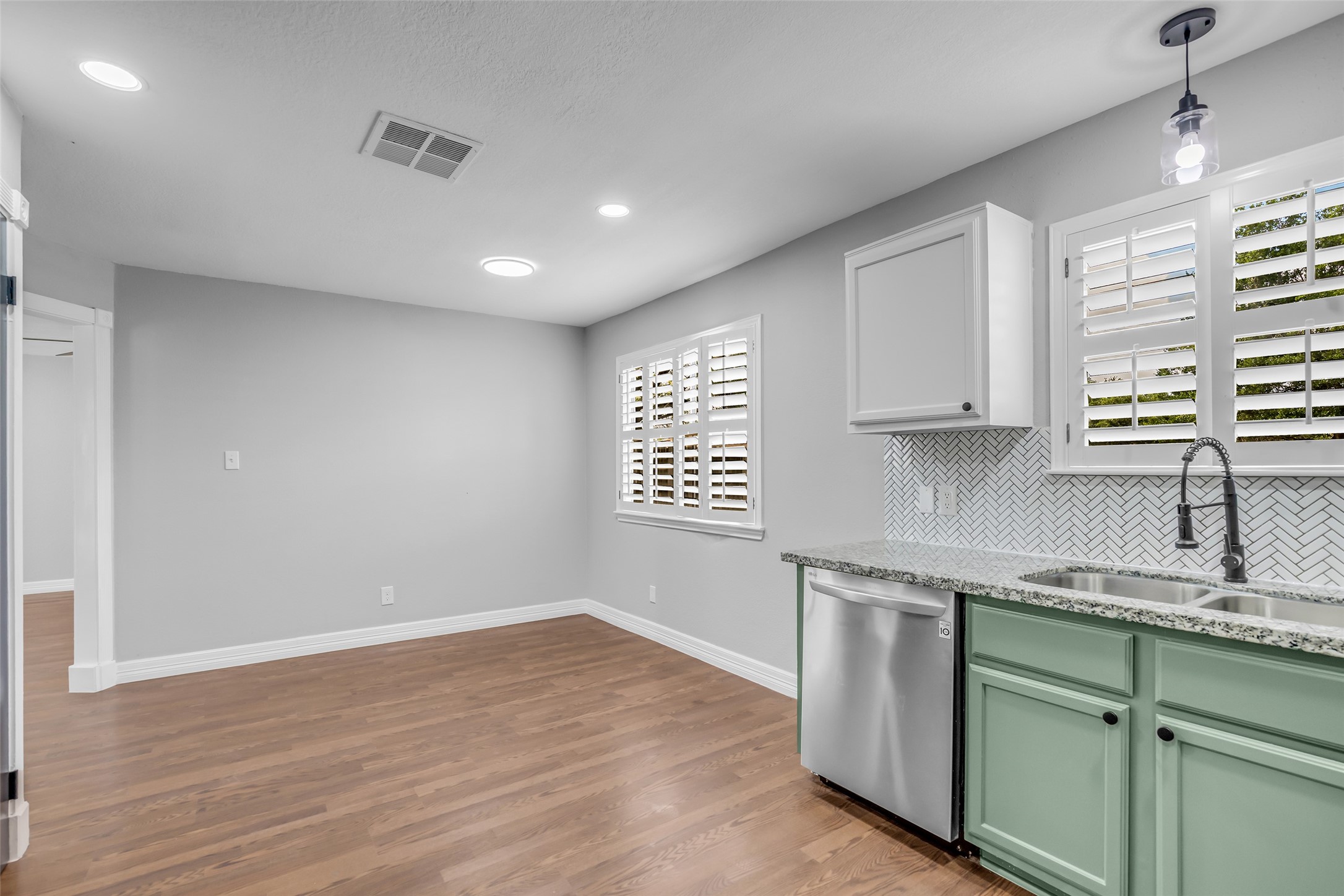 4795 Slade Ben Lane Alvin, TX 77511 - Photo 13 of 25 a kitchen with granite countertop white cabinets and white appliances