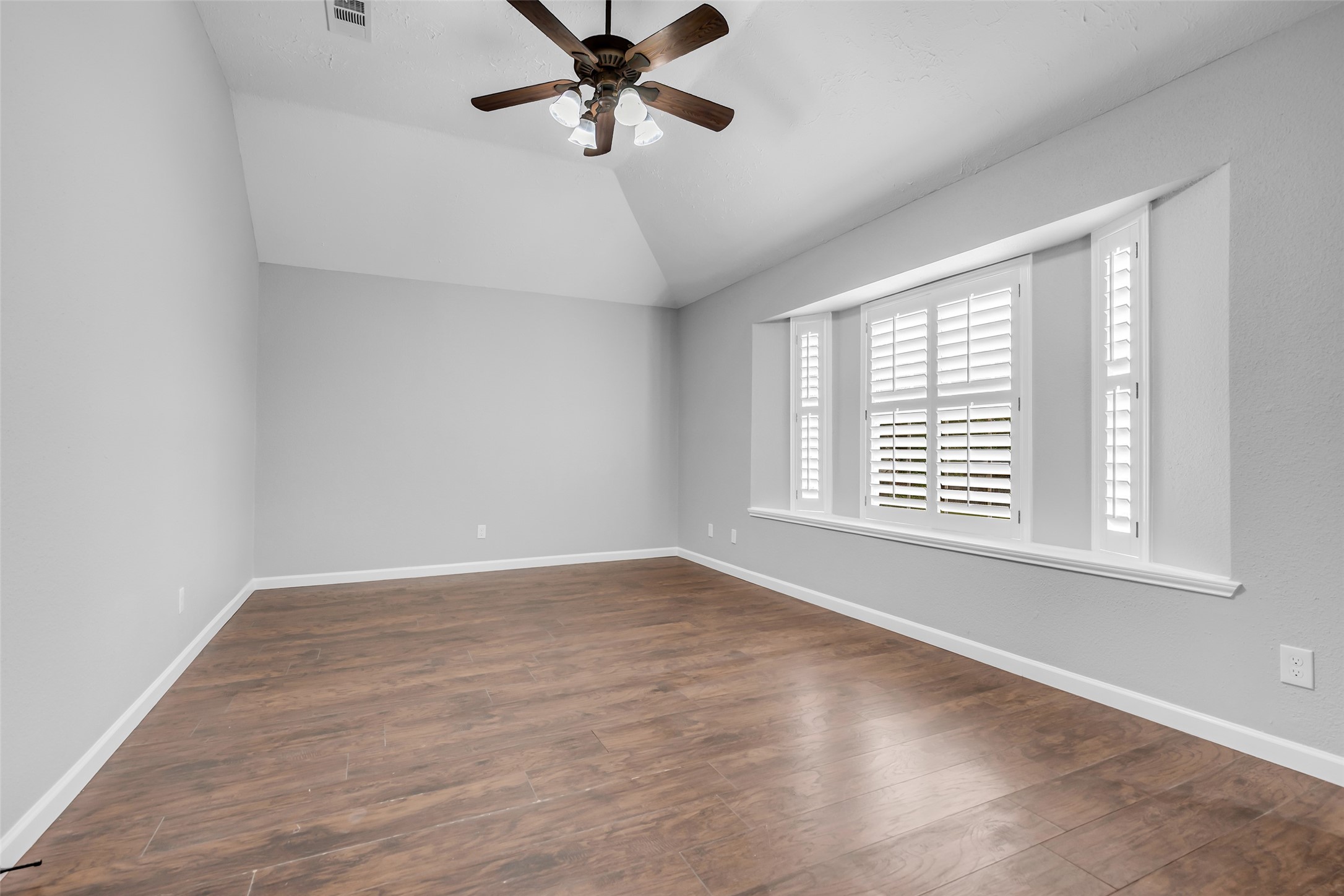 4795 Slade Ben Lane Alvin, TX 77511 - Photo 15 of 25 wooden floor in an empty room with a window