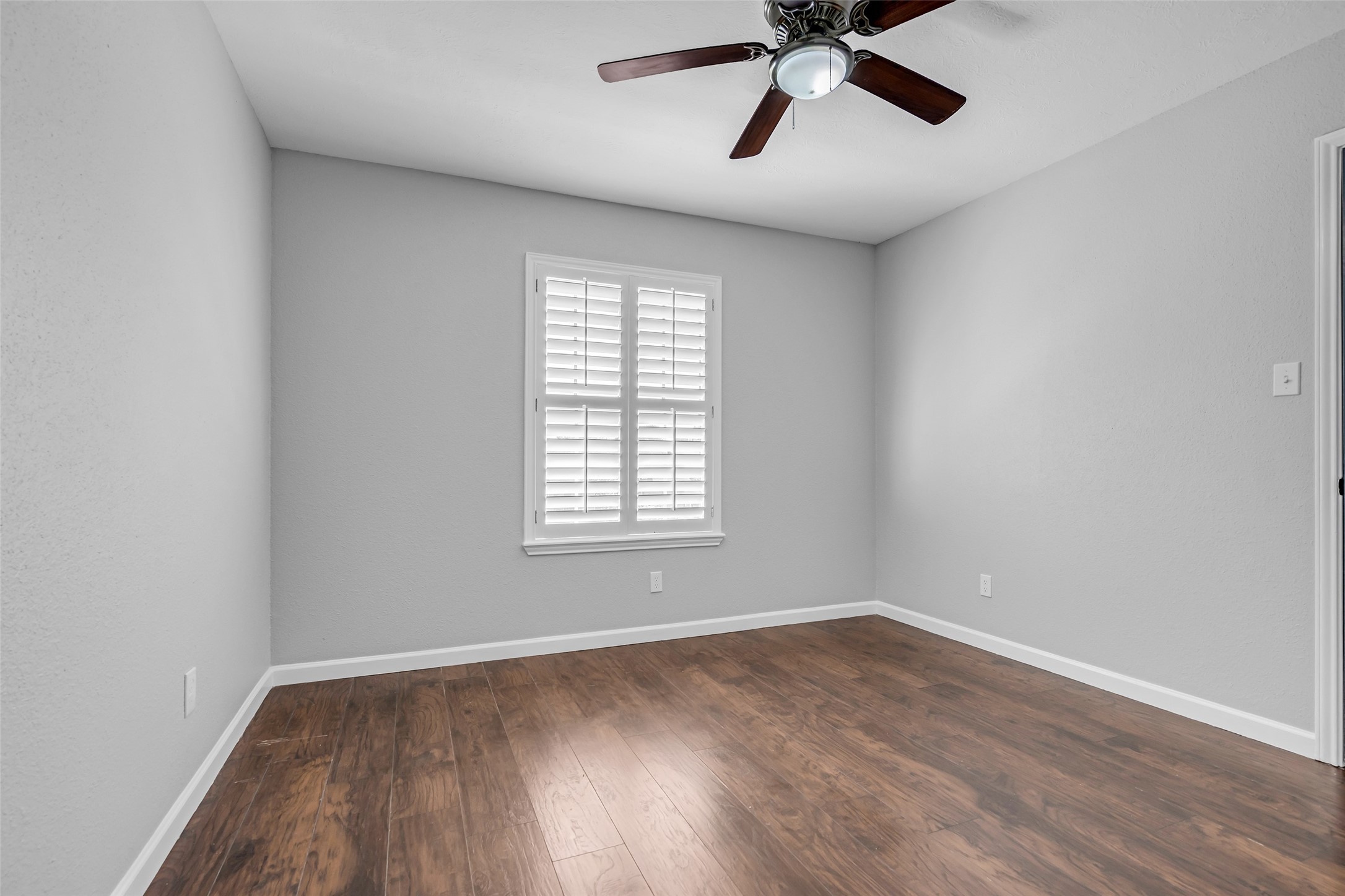 4795 Slade Ben Lane Alvin, TX 77511 - Photo 18 of 25 wooden floor in an empty room with a window