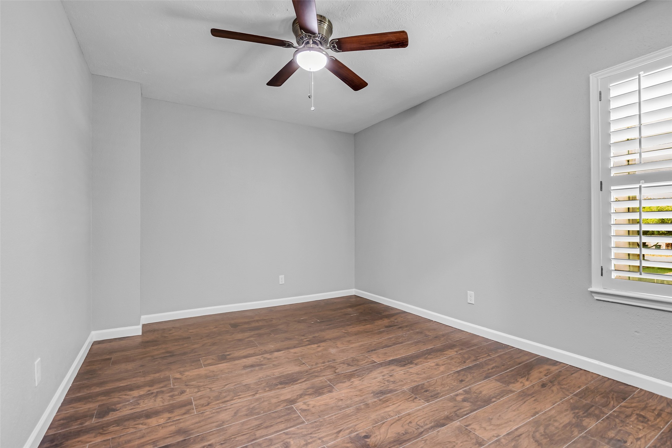 4795 Slade Ben Lane Alvin, TX 77511 - Photo 20 of 25 wooden floor in an empty room with a window