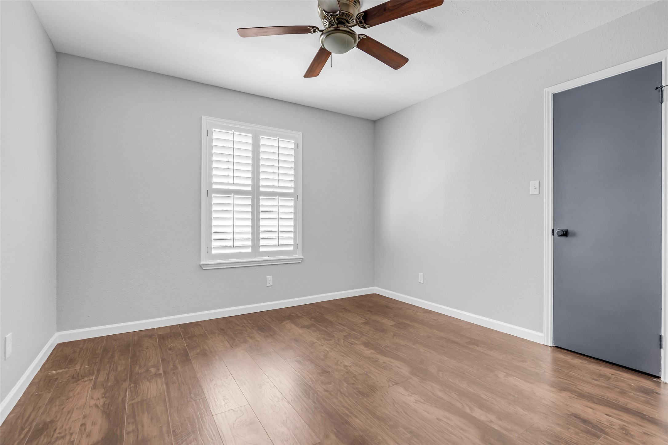 4795 Slade Ben Lane Alvin, TX 77511 - Photo 22 of 25 a view of a room with wooden floor and windows